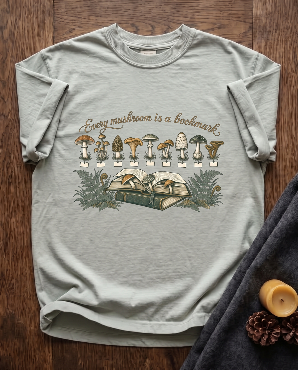 Every Mushroom Is a Bookmark - Bay sage green Comfort Colors tee, styled flat lay